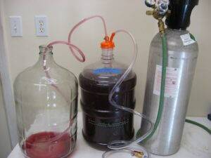How is CO2 used for inerting wine tanks and barrels?